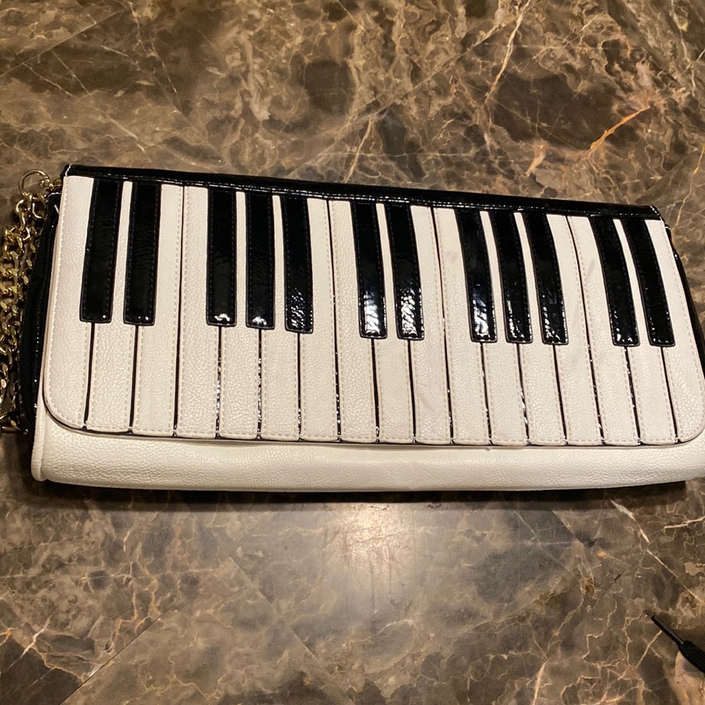 Betsy Johnson large piano clutch with gold chain. Like new. 14”x7”